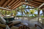 Huge double sliding glass doors open up to the Caribbean